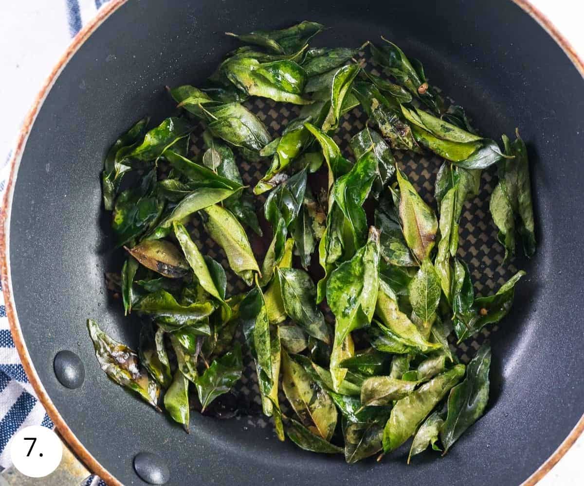 frying curry leaves in a pan