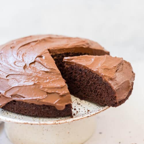 chocolate orange cake on a cake platter with slice out