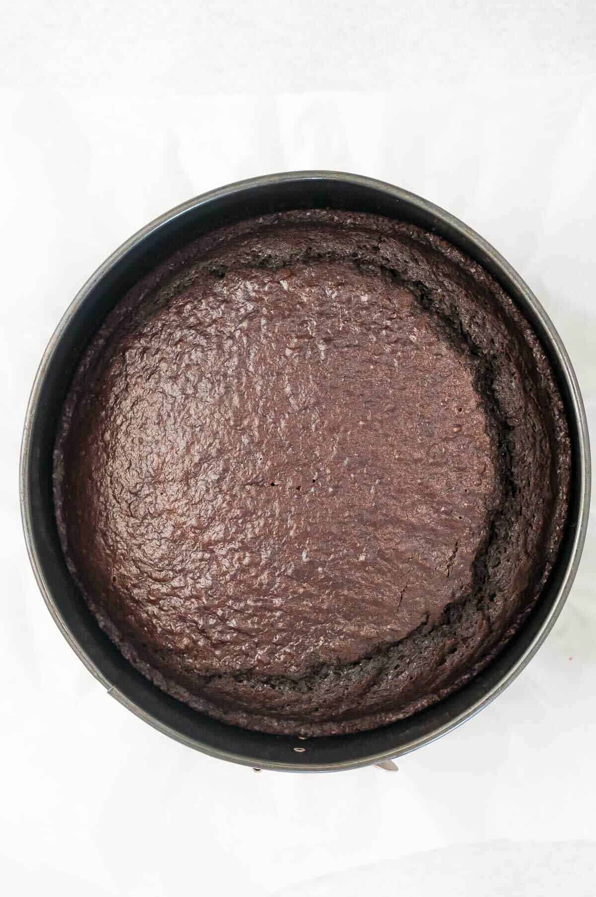 baked chocolate cake in a round cake tin
