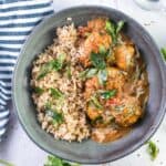 grey bowl with butter chicken meatballs and rice