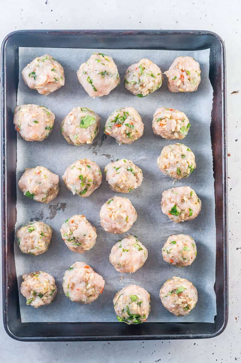 chicken meatballs on a try with baking paper