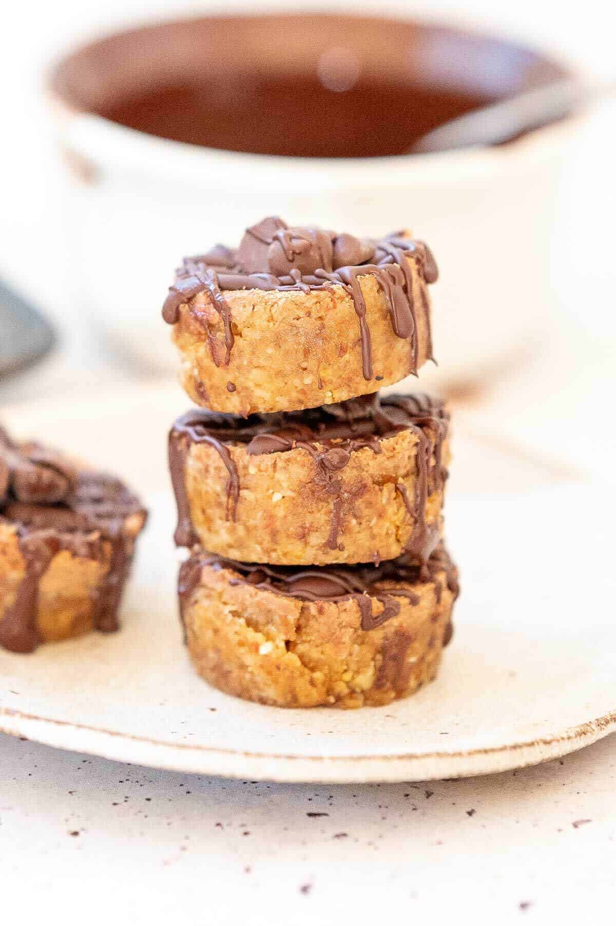 3 stacked mini cheesecakes with chocolate drizzle