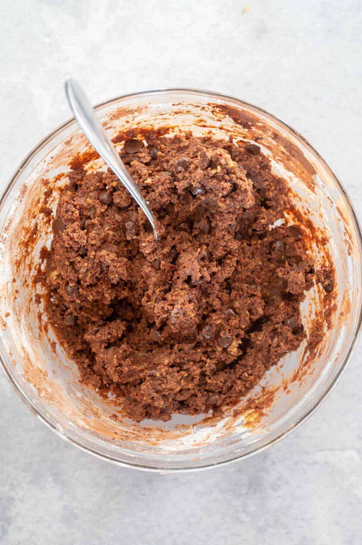 mixing dry ingredients into wet ingredients in a bowl