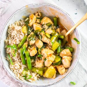 lemon chicken stirfry in a bowl with rice