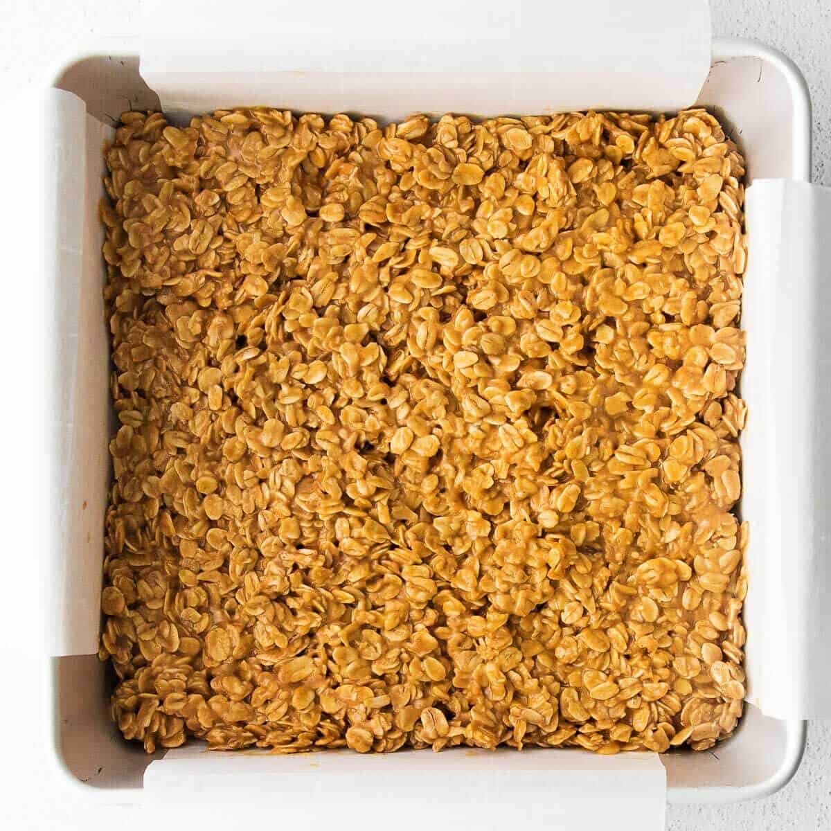 granola bar mixture spread out in a pan