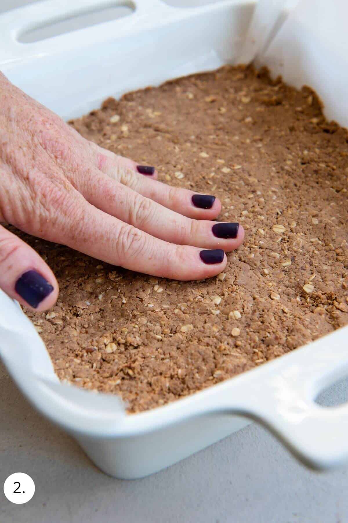 pressing protein bar mixture into pan