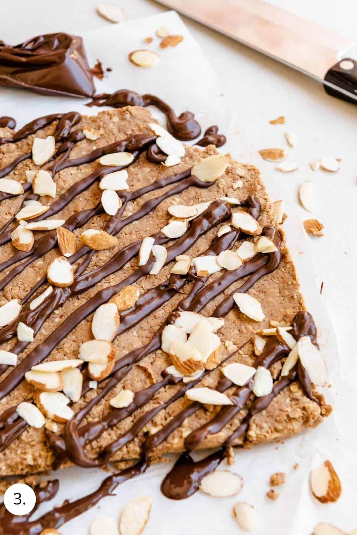 decorating protein bars with chocolate and almonds