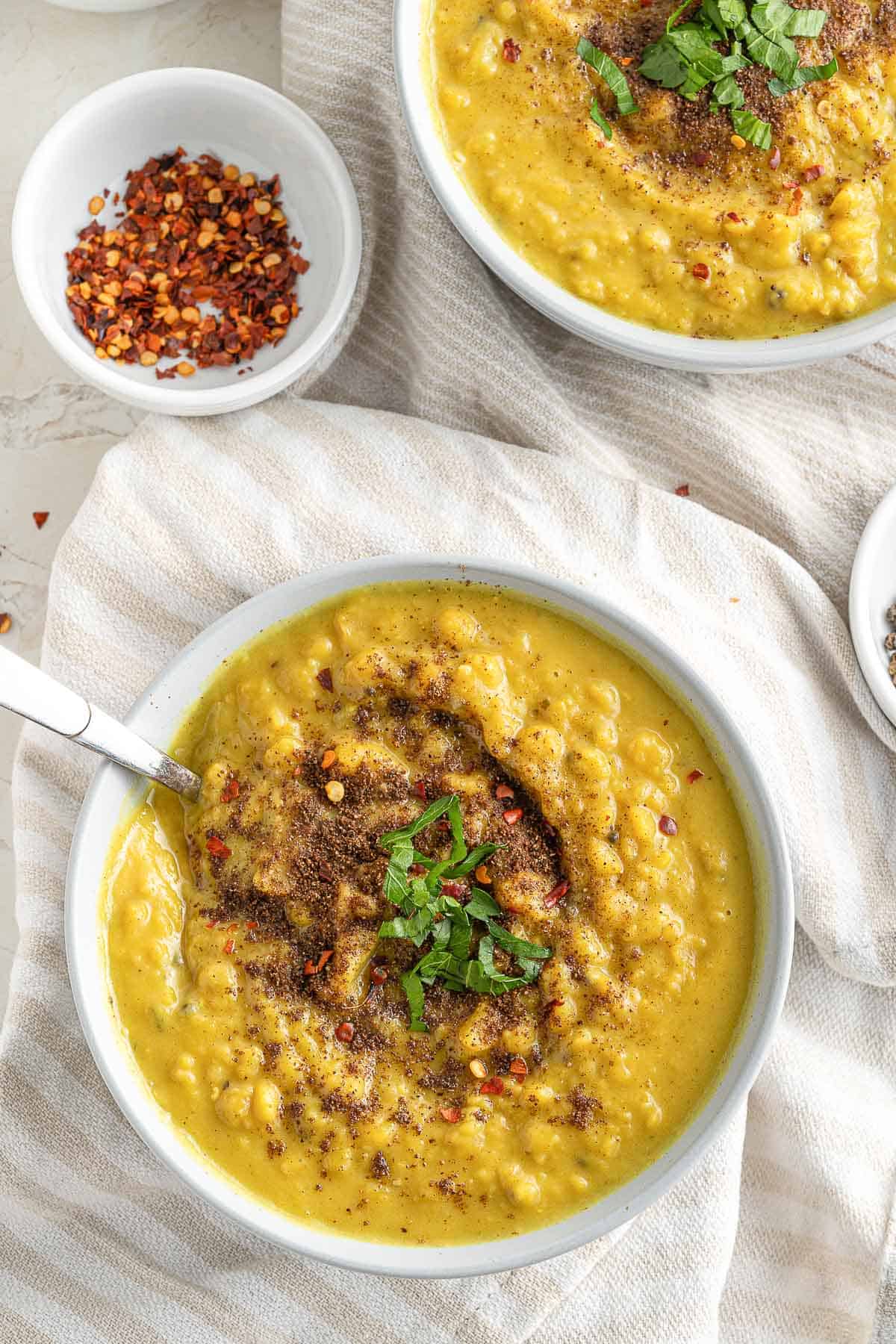 a bowl of lentil soup with spoon in