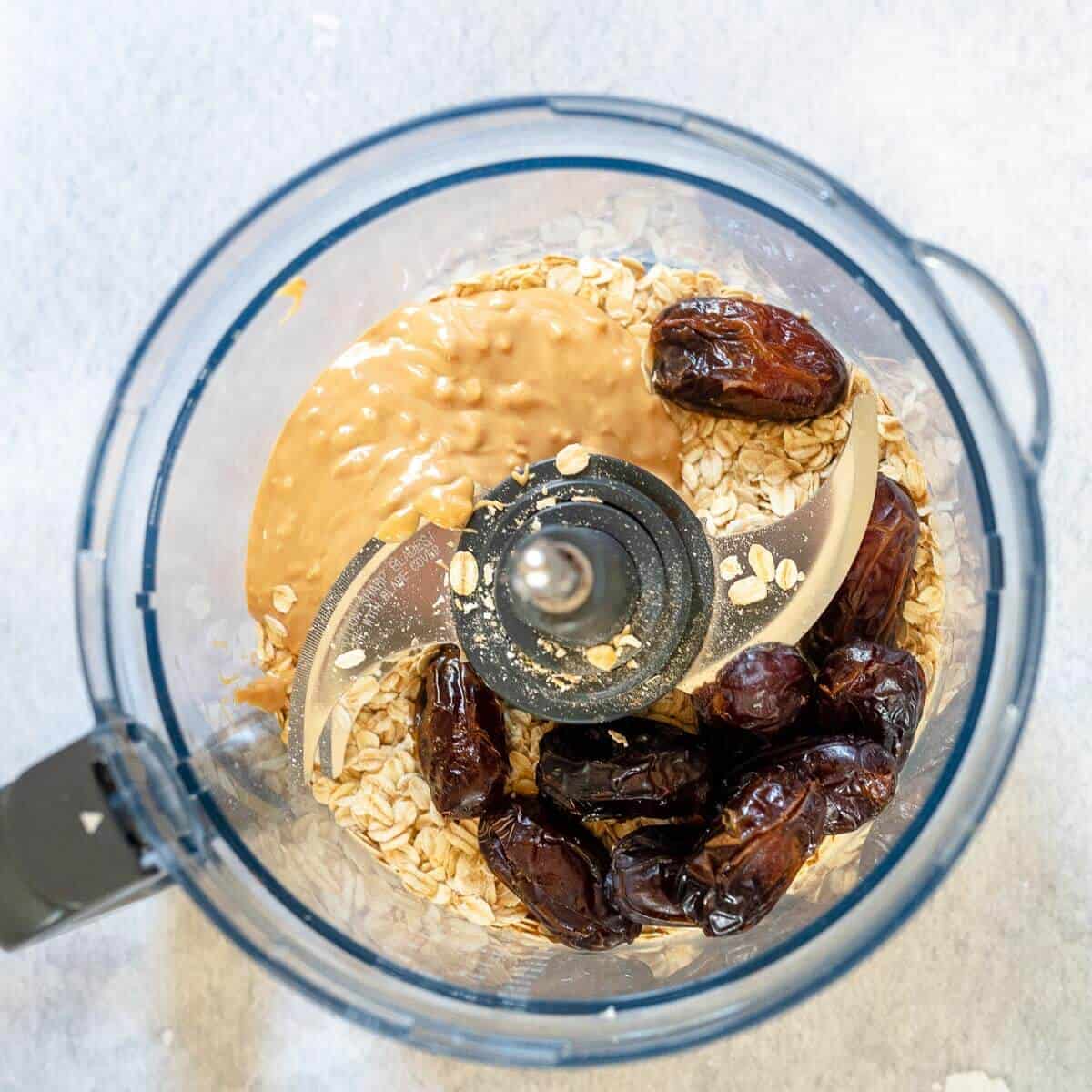 ingredients for peanut butter oatmeal balls in a food processor