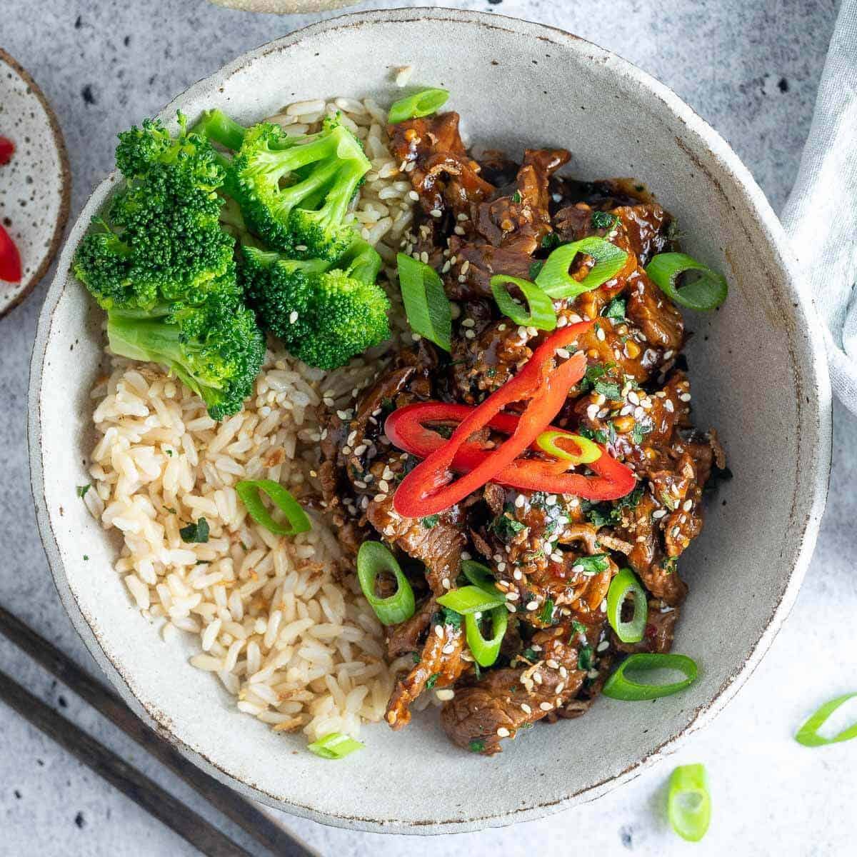 beef in garlic sauce with rice and broccoli in a bowl