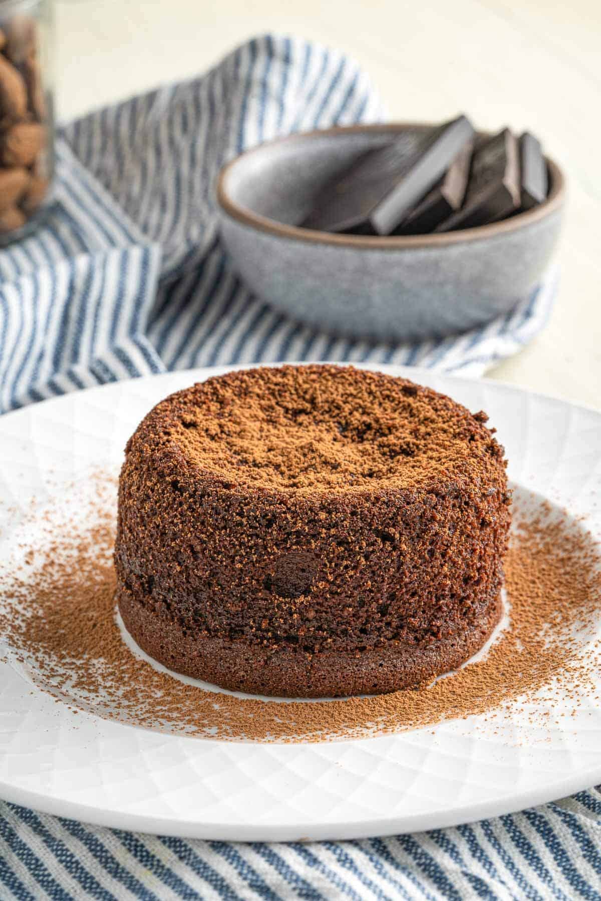 chocolate lava cake on a plate dusted with chocolate powder