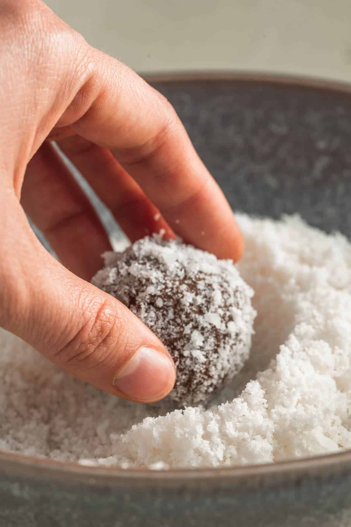 rolling a sweet potato truffle in coconut