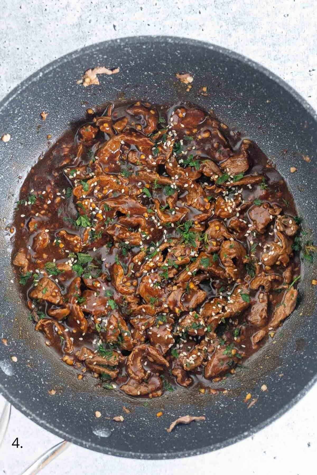 garlic beef in a pan with sauce