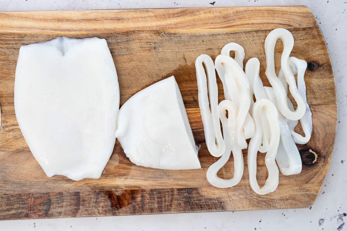 calamari tubes cut into circles on a cutting board