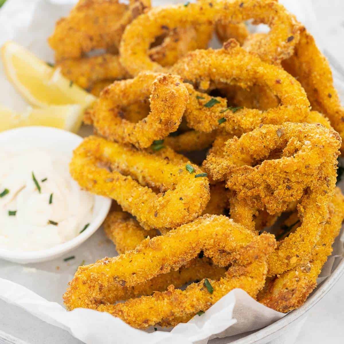 crispy calamari in a bowl with dipping sauce