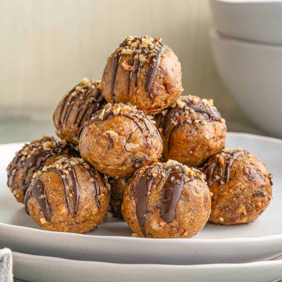 pecan pie truffles stacked on a white plate