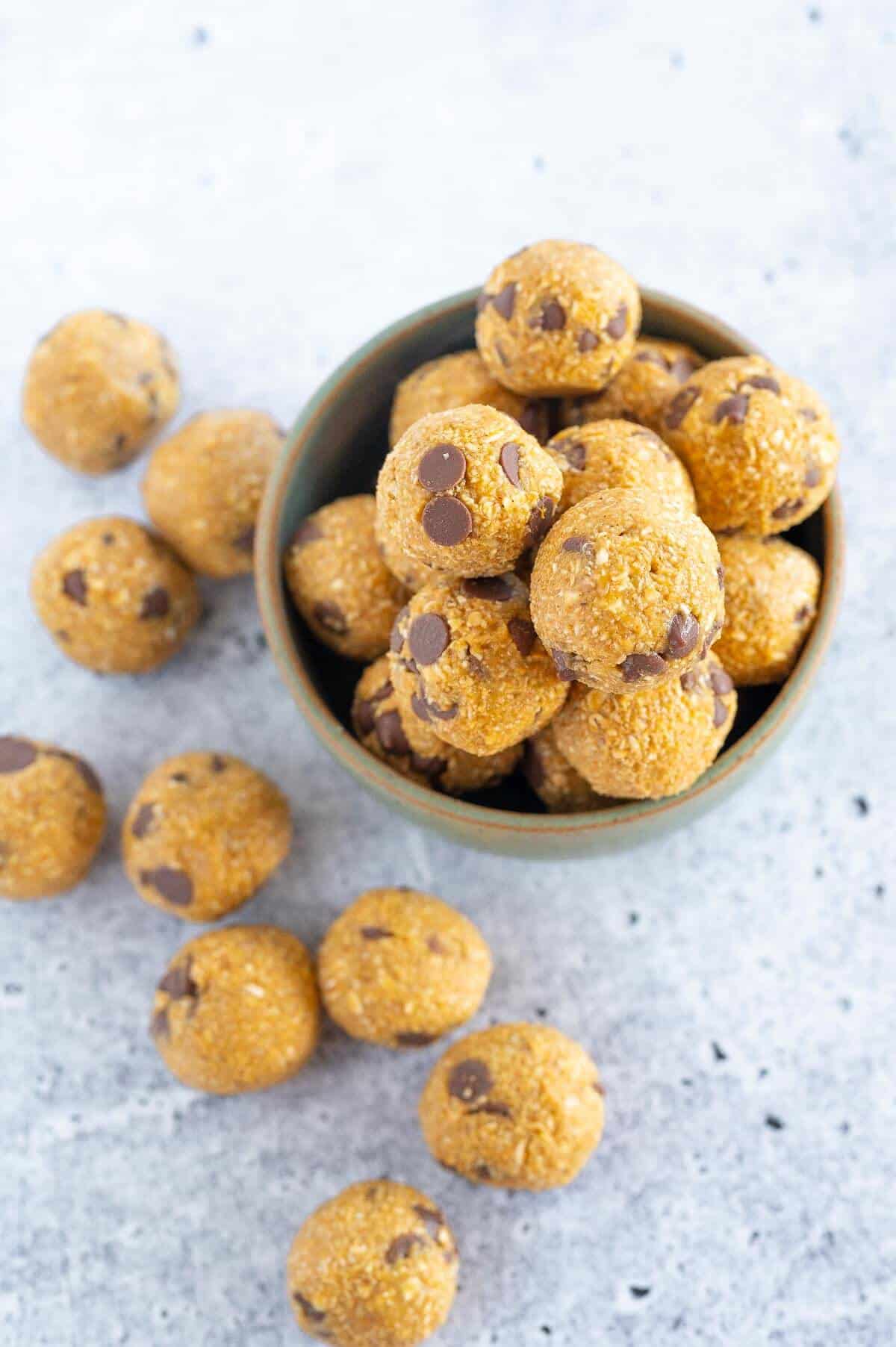 pumpkin energy balls scattered on a bench