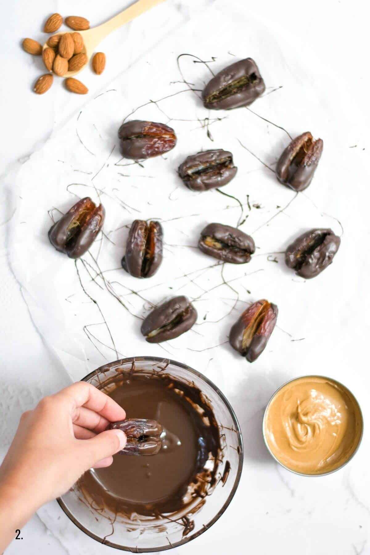 dipping dates into a bowl of melted chocolate