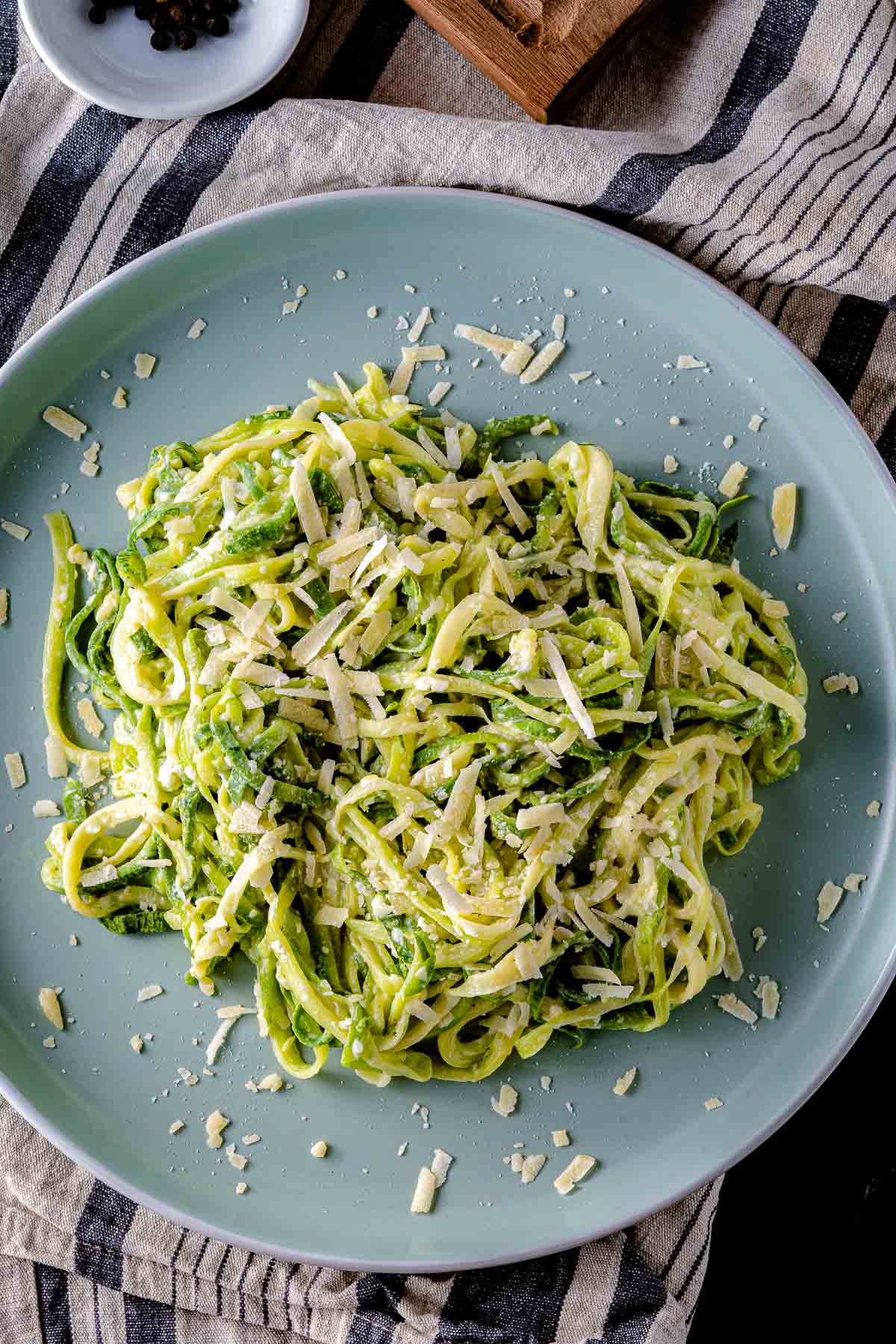 creamy garlic parmesan zucchini noodles on a blue plate