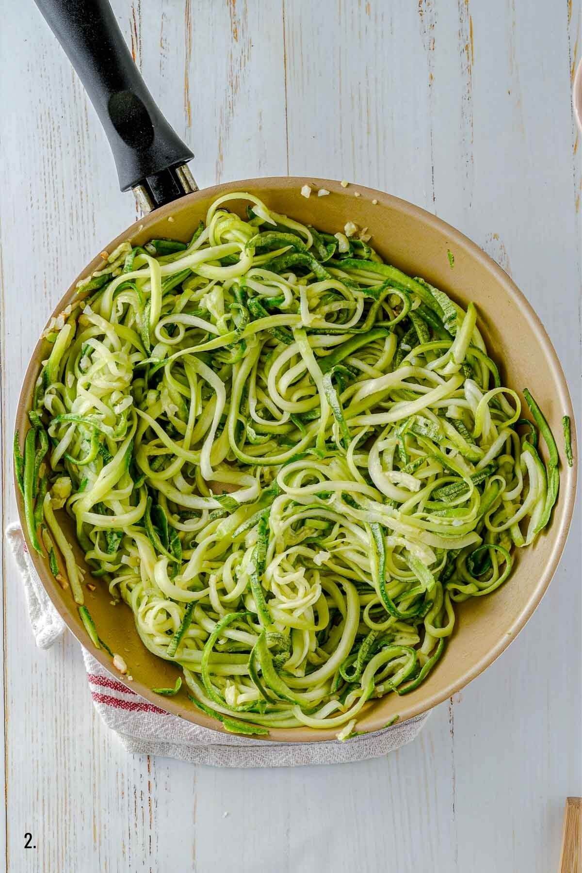 coking zucchini noodles in a pan