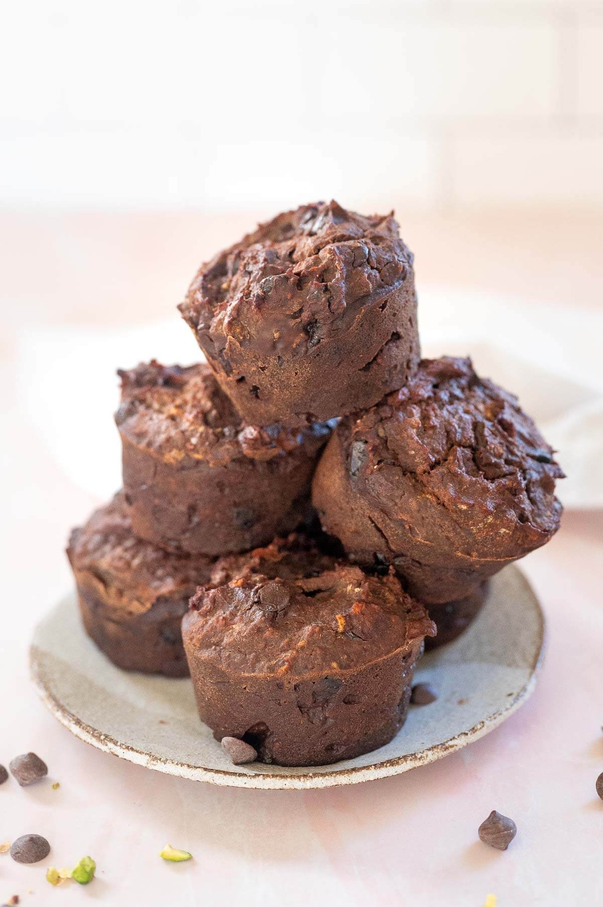 a stack of 5 sweet potato chocolate muffins on a plate