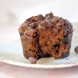 a single chocolate sweet potato muffin with a bite ot