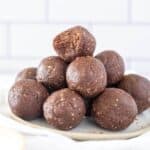 a stack of chocolat e protein balls on a plate