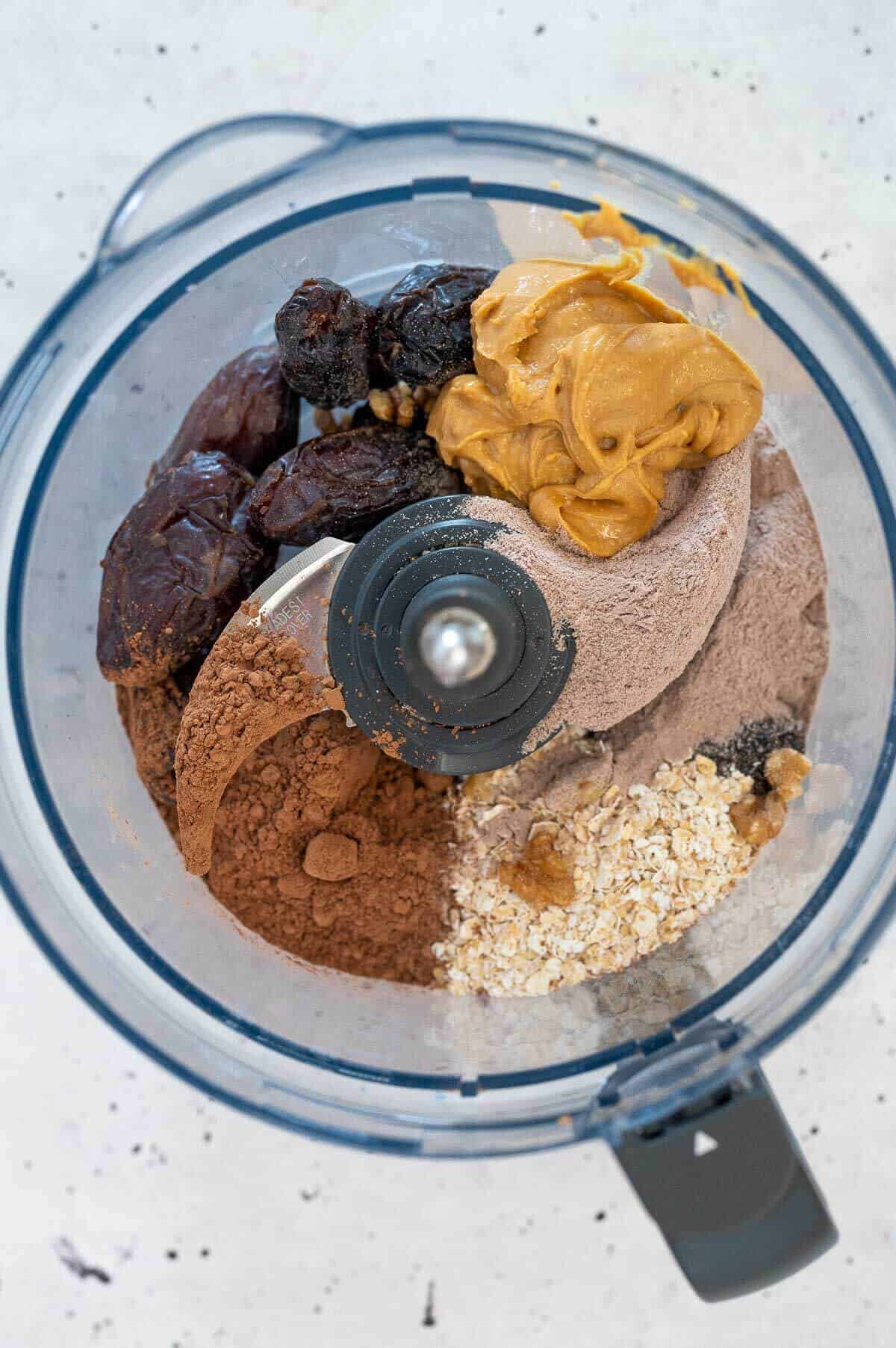 ingredients for chocolate date protein ball in a food processor