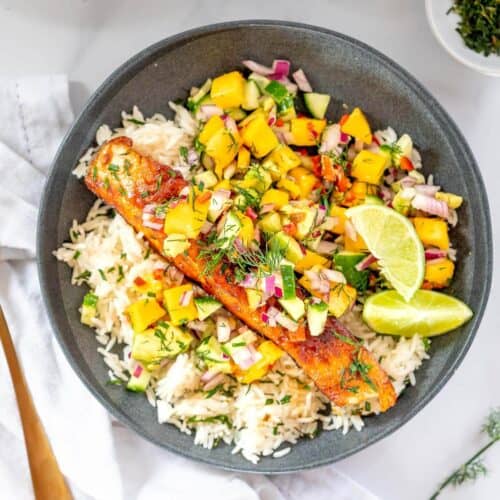 grey bowl with salmon, mango salsa and rice