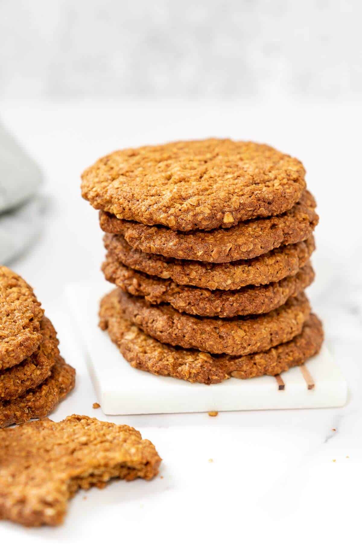 6 anzac biscuits stacked on a serving tile