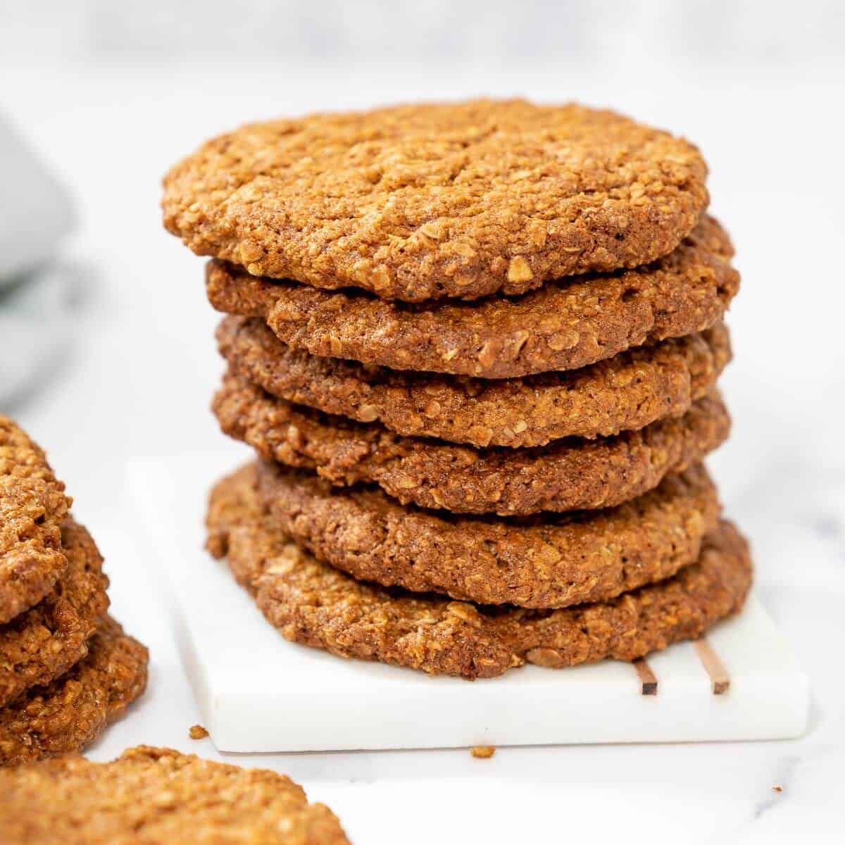 anzac biscuits stacked in a pile on a plate