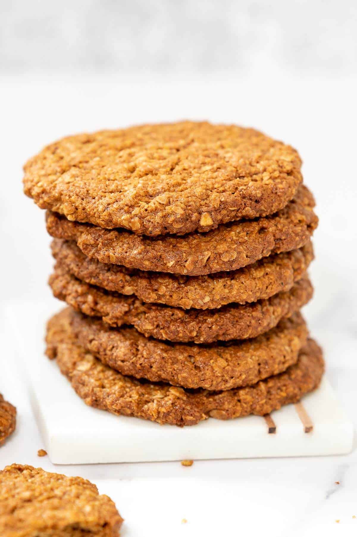 6 stacked anzac biscuits on a square plate