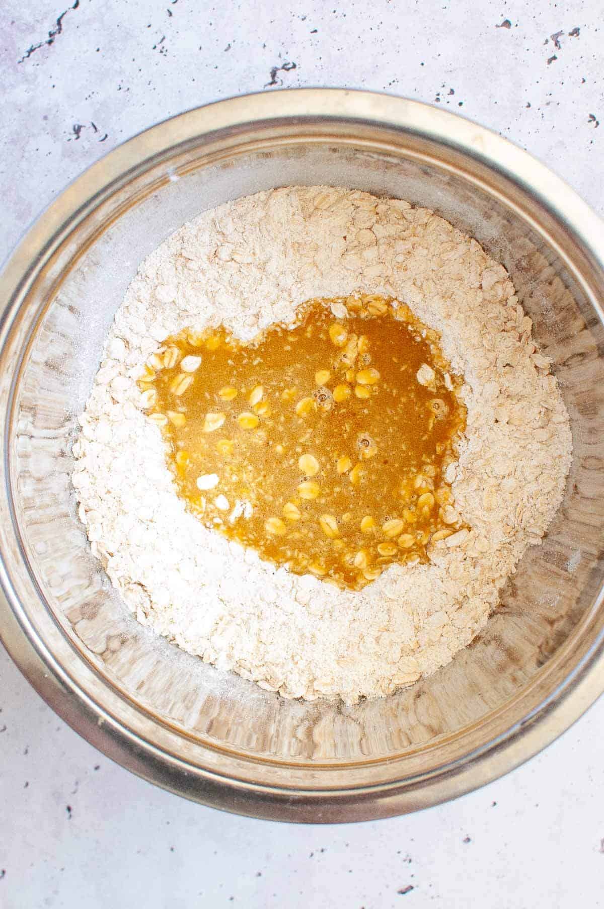 pouring wet ingredients into dry ingredients in a bowl