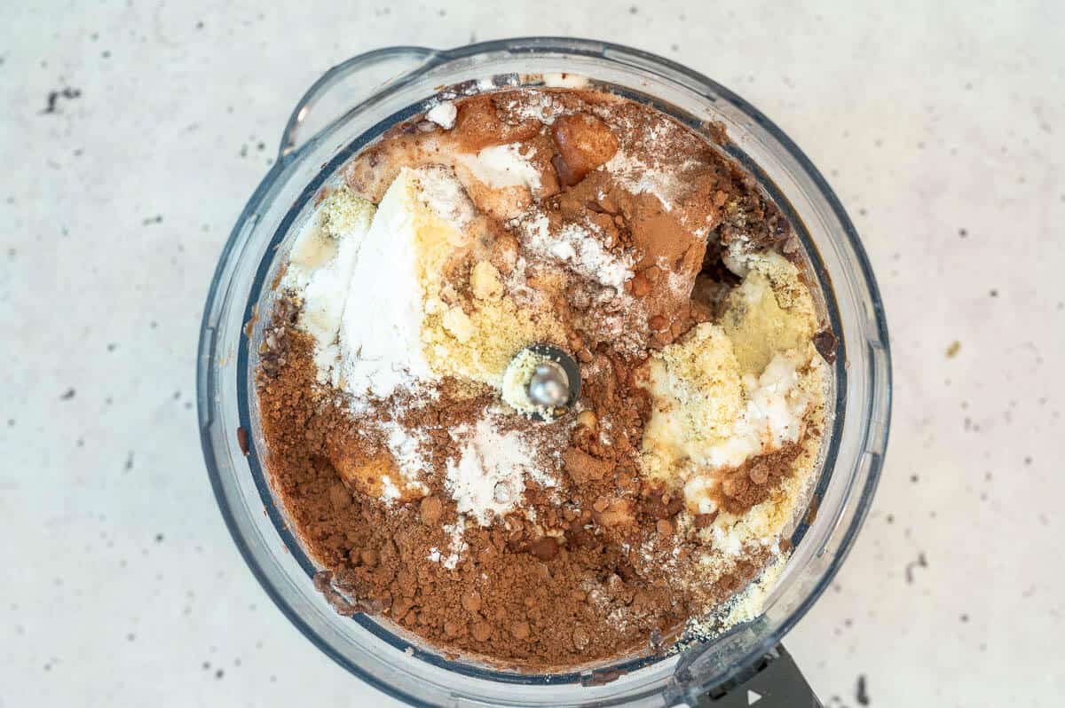 all the ingredients for black bean muffins in a food processor