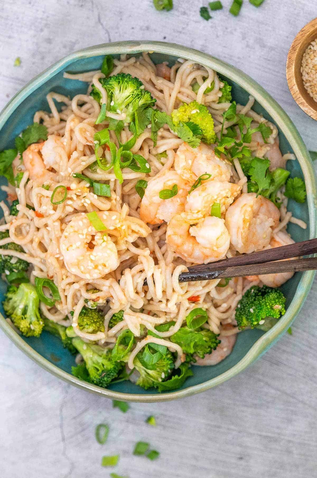 garlic prawn stir fry noodles in bowl with chopsticks