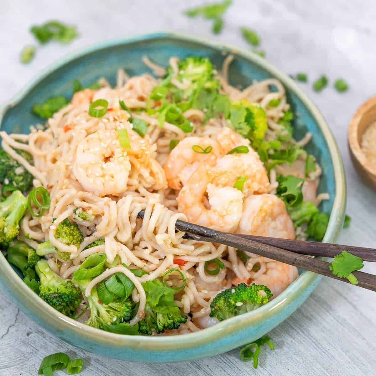 garlic prawn noodles with broccoli in a bowl