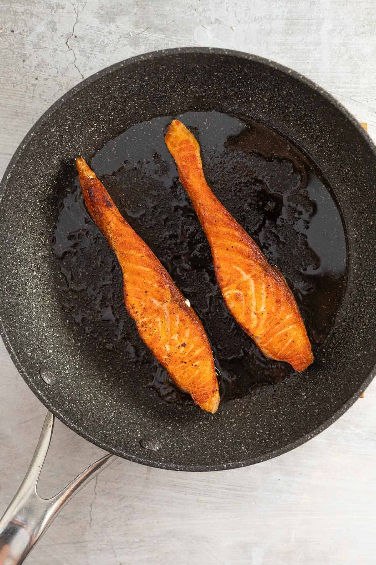 pan frying salmon in a skillet