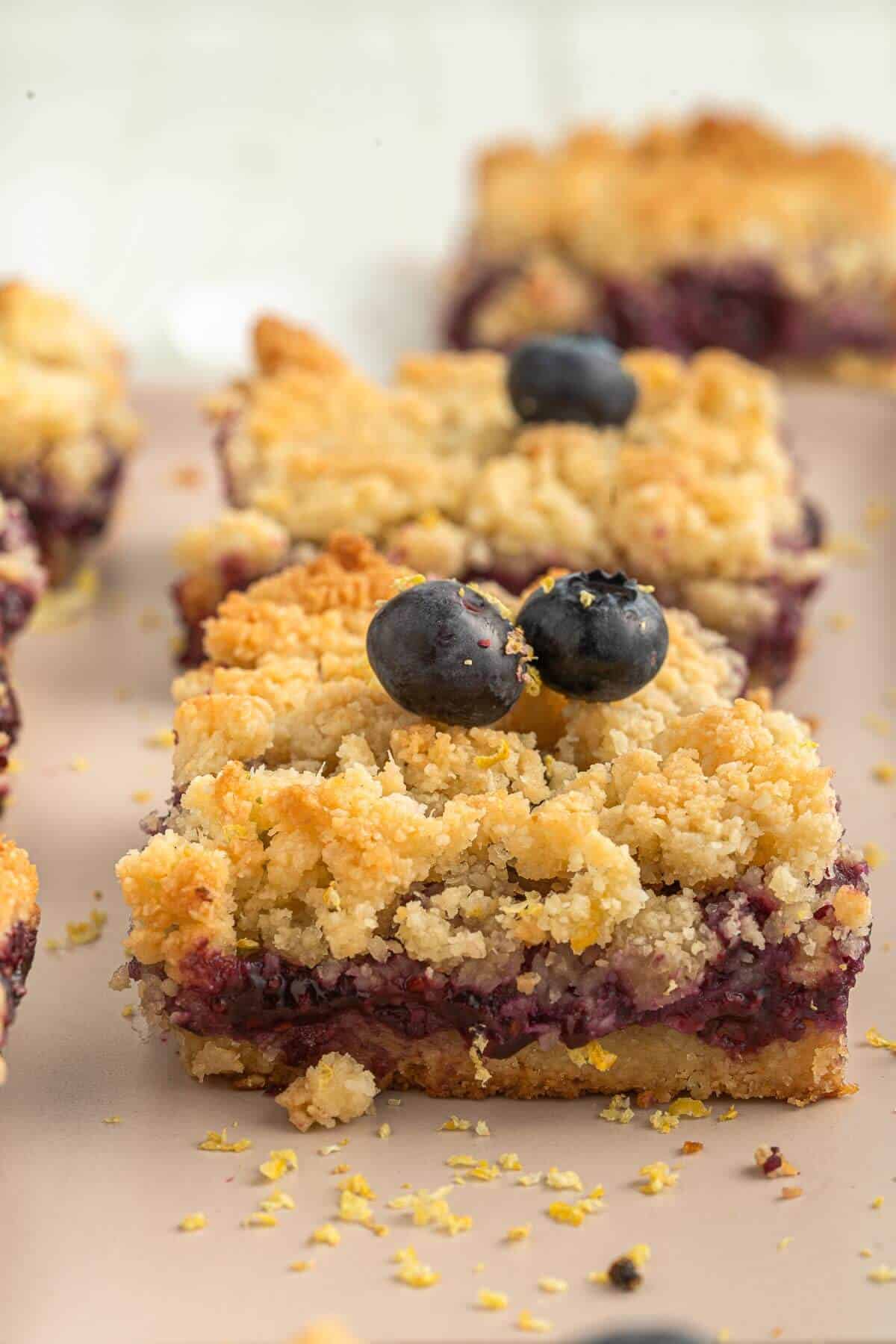 blueberry and lemon crumb bar on a tray