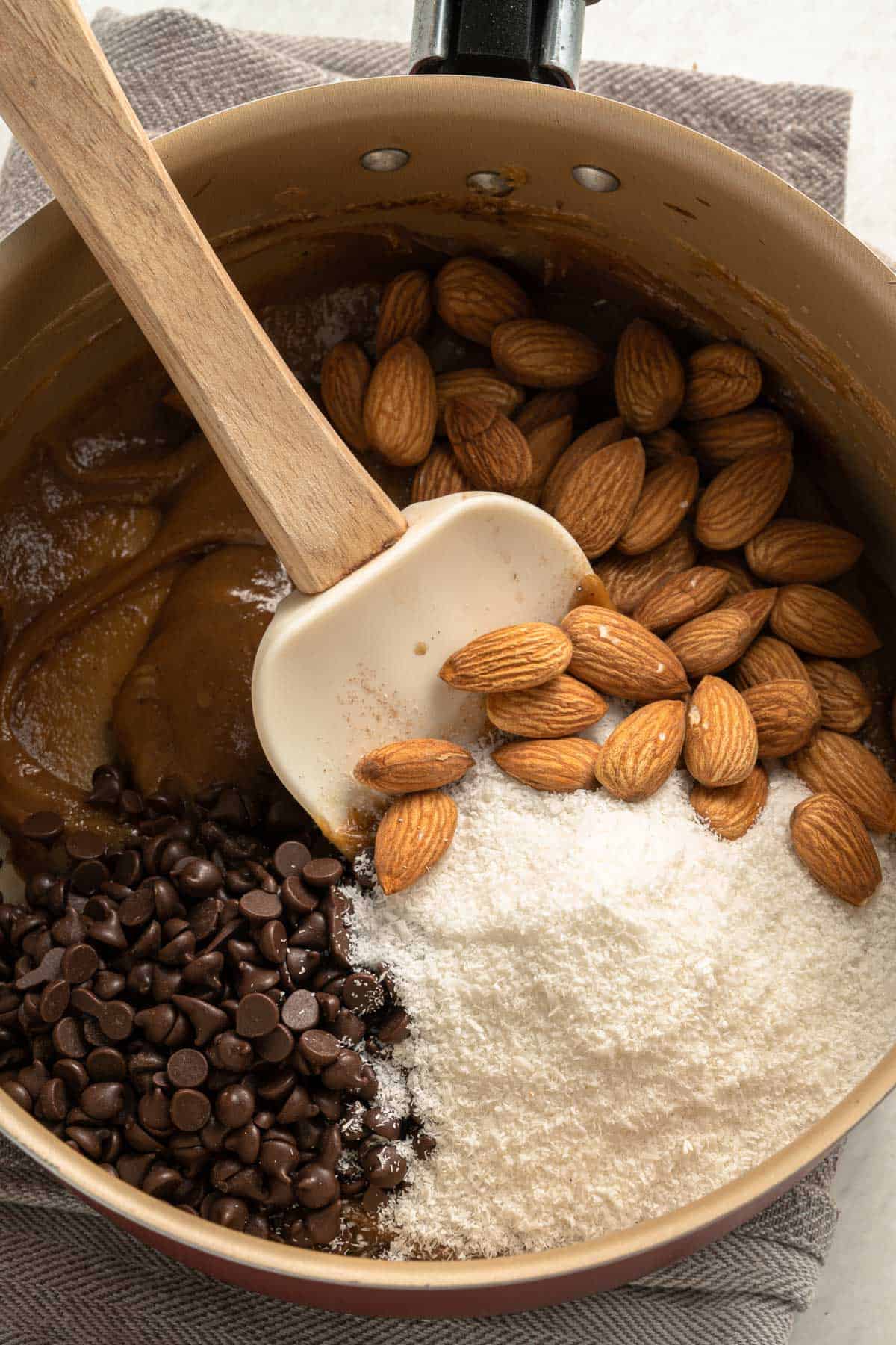 mixing chocolate ships, coconut and almonds into bars