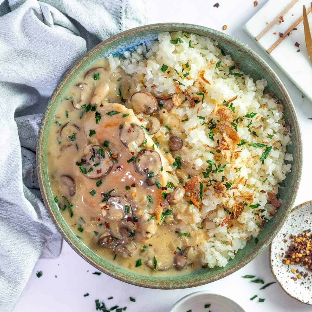 creamy mushroom chicken in a bowl with cauliflower rice