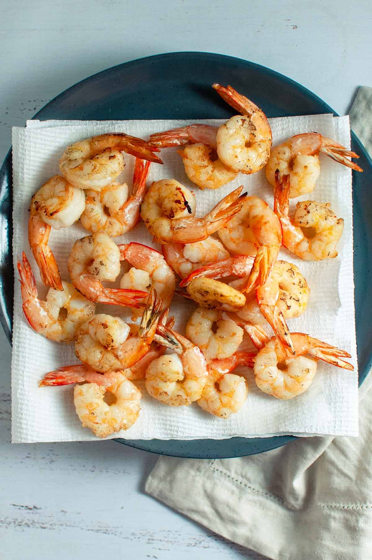 cooked prawns draining on kitchen towel