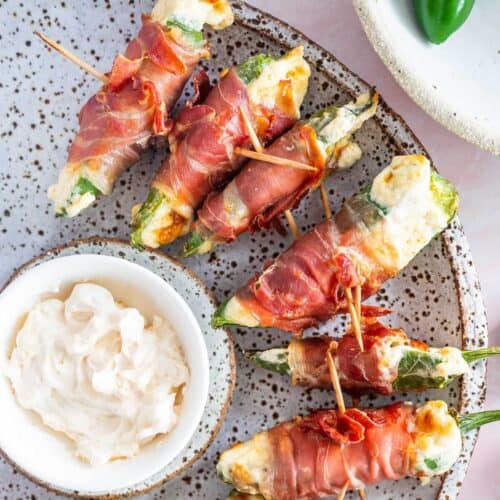 air fryer jalapeno poppers with bacon on a plate