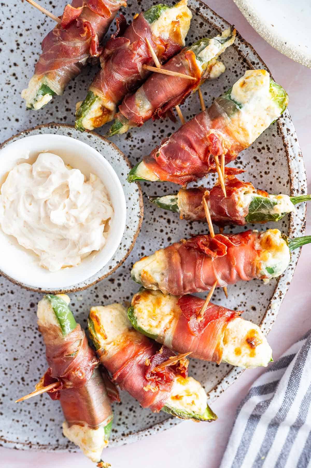 Bacon wrapped jalapeno poppers on a plate