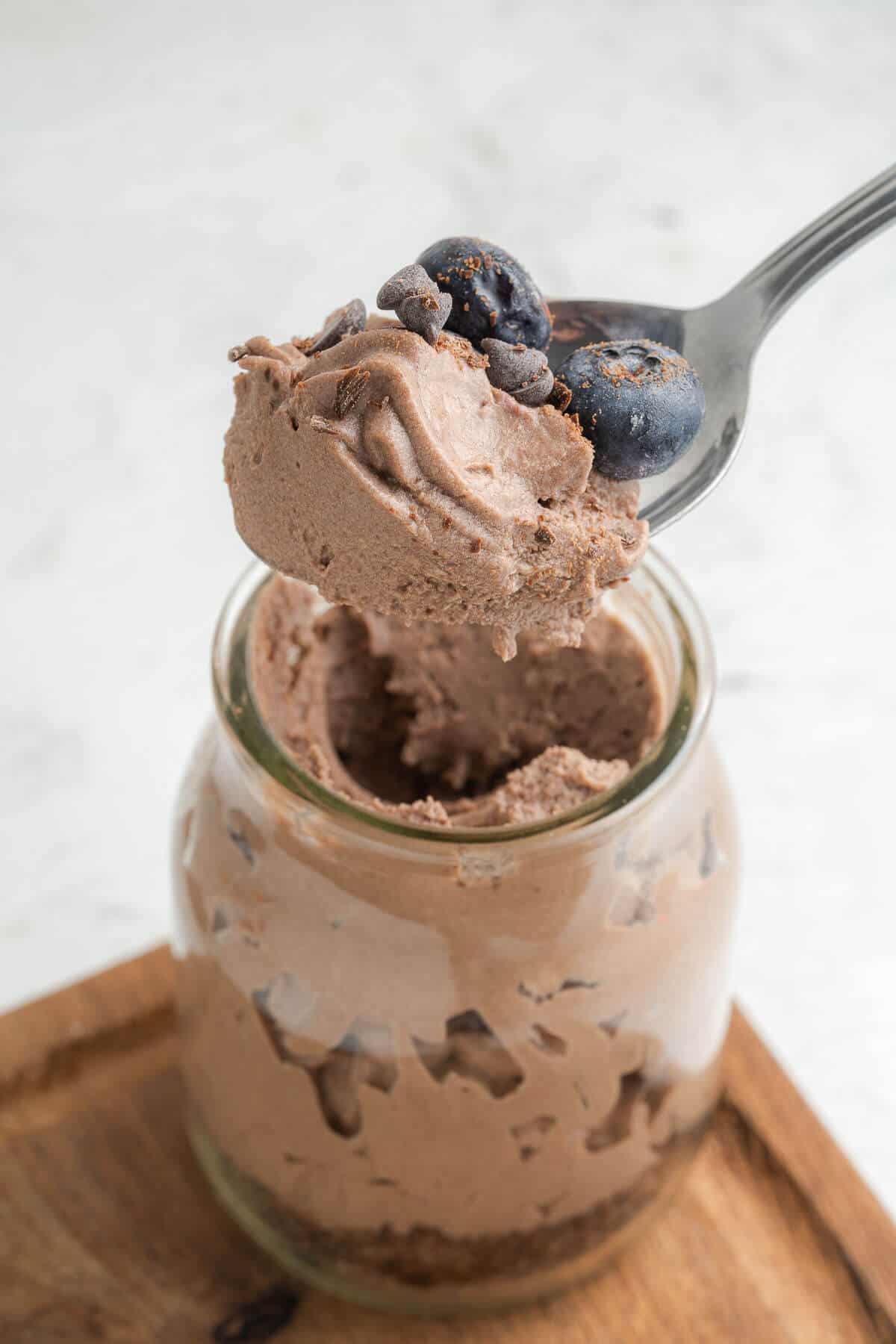 a spoonful of chocolate cheesecake in a jar