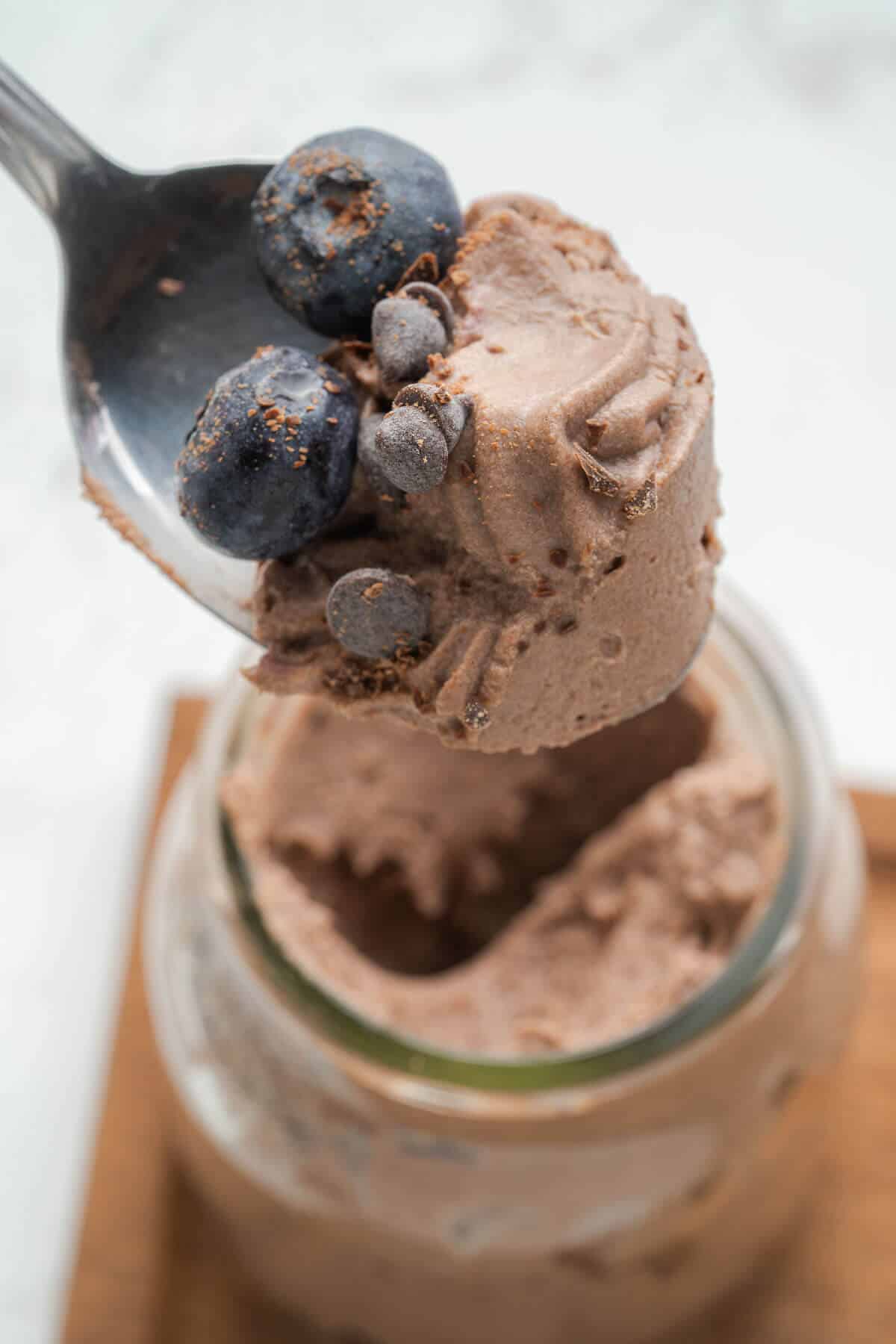 chocolate cheesecake in a jar on a spoon