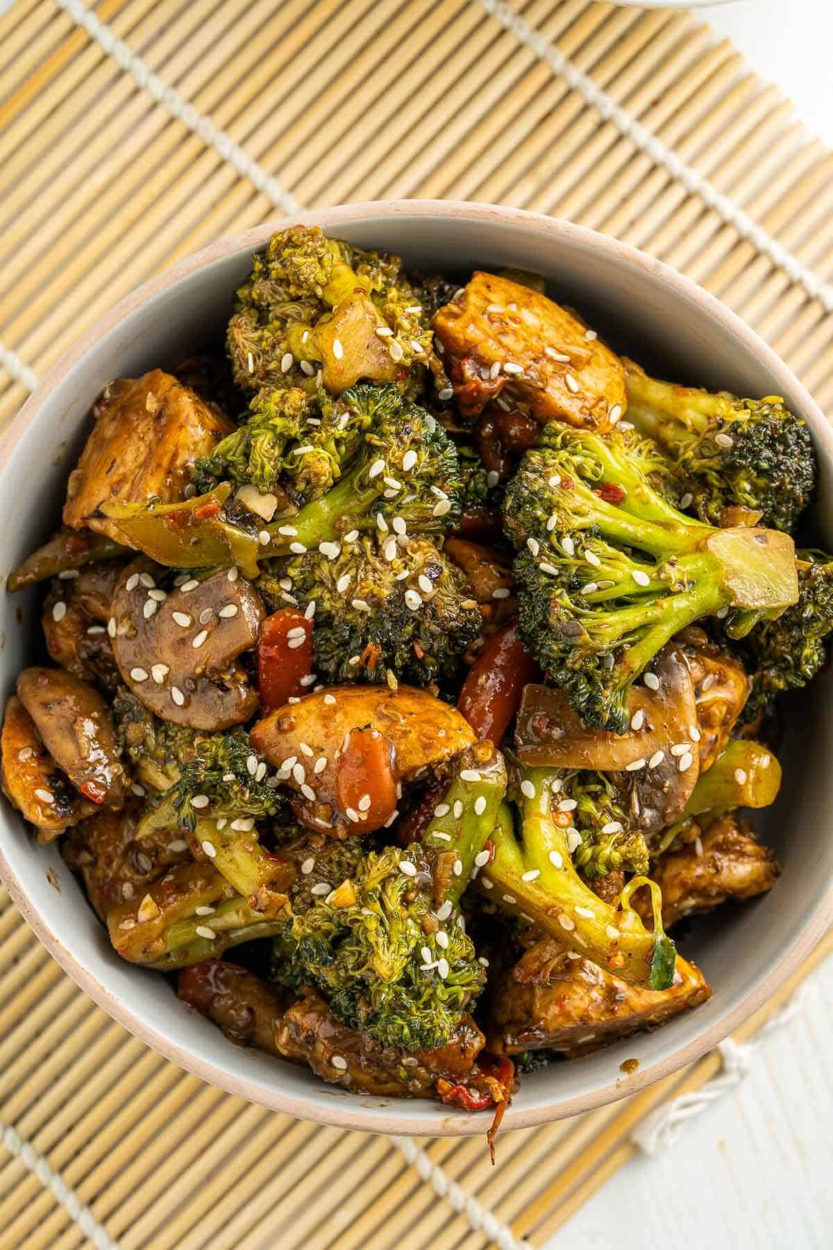 overhead photo of a bowl of saucy chicken broccoli stir fry