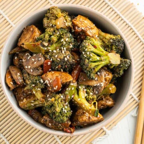 chicken and broccoli stir fry bowl with chopsticks