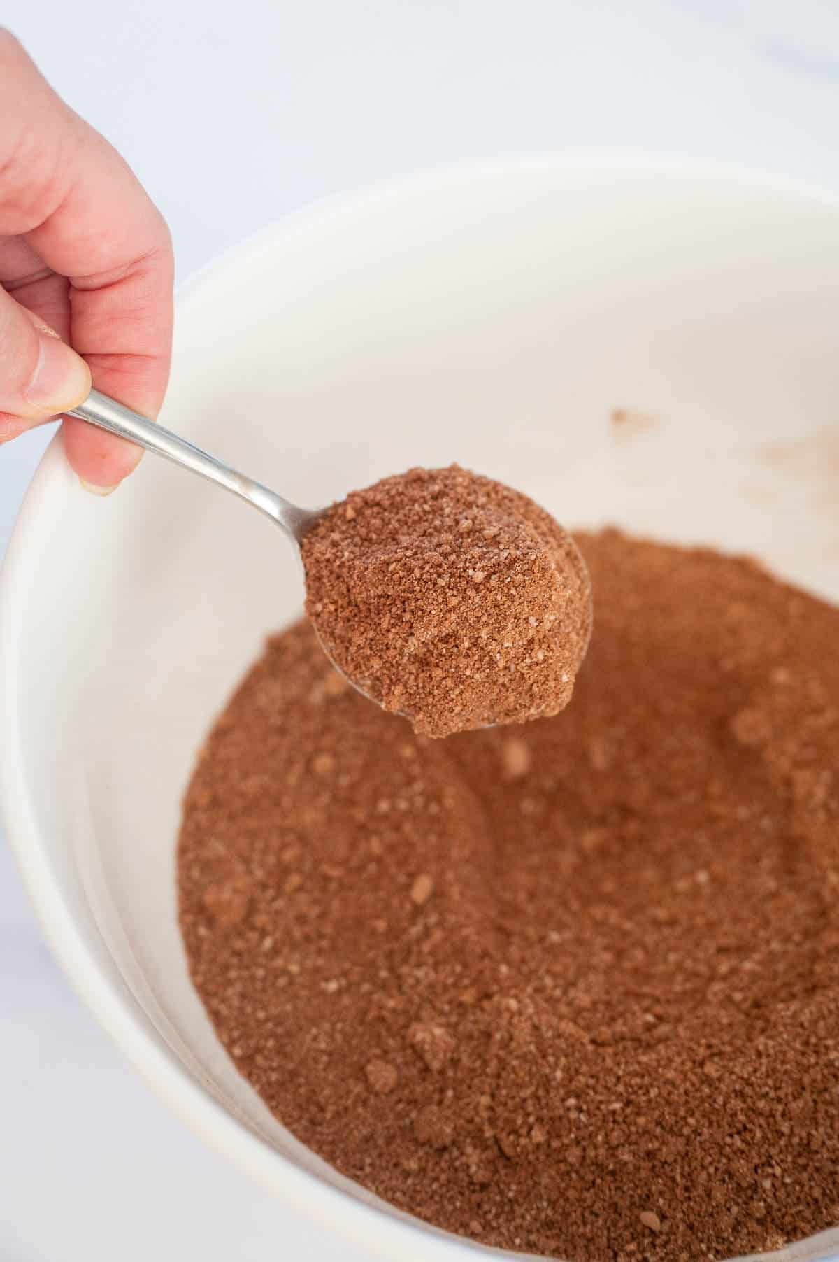 mixing dry ingredients in a bowl ready to make pumpkin brownies