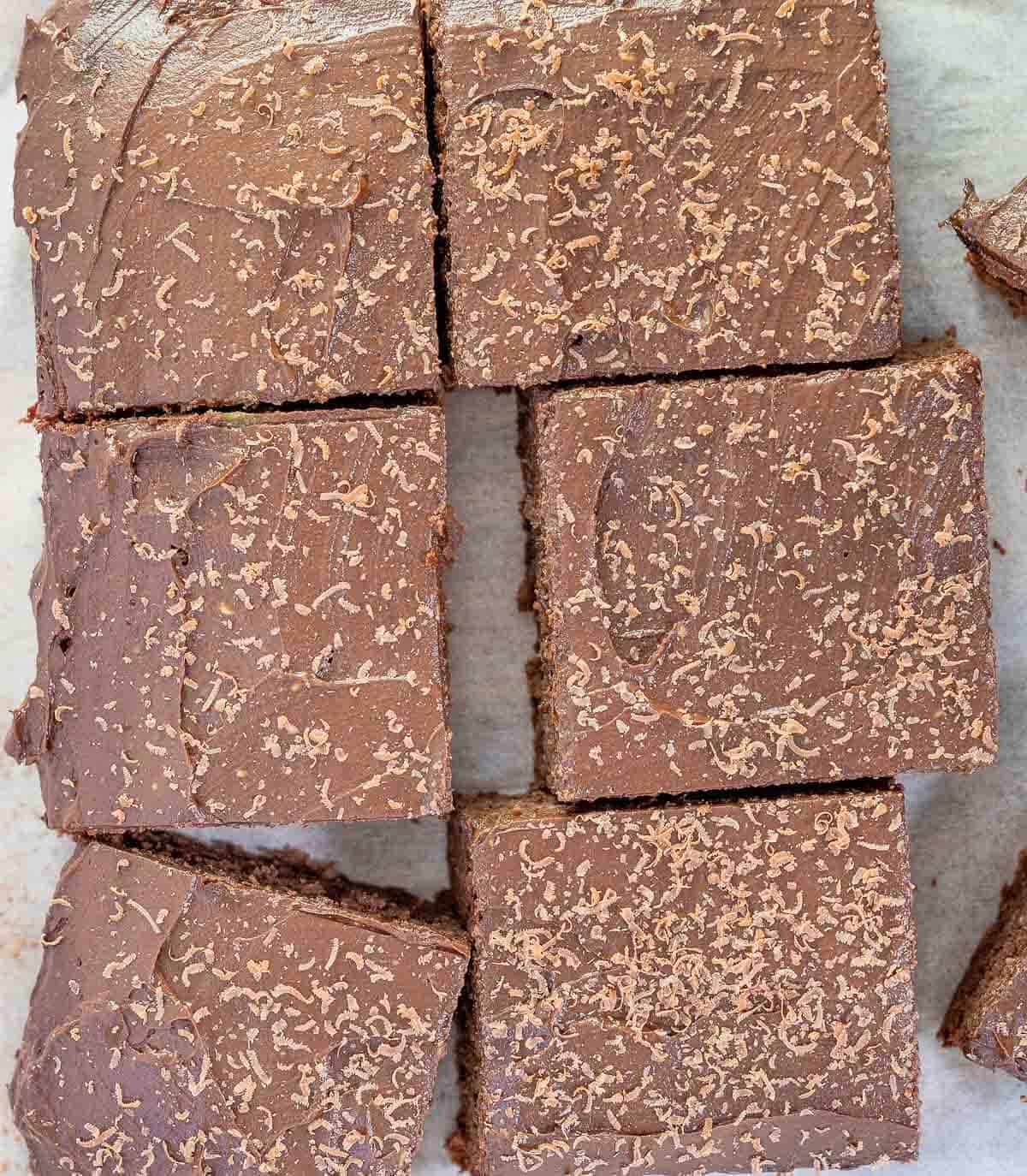 6 pieces of chocolate chickpea cake with frosting overhead
