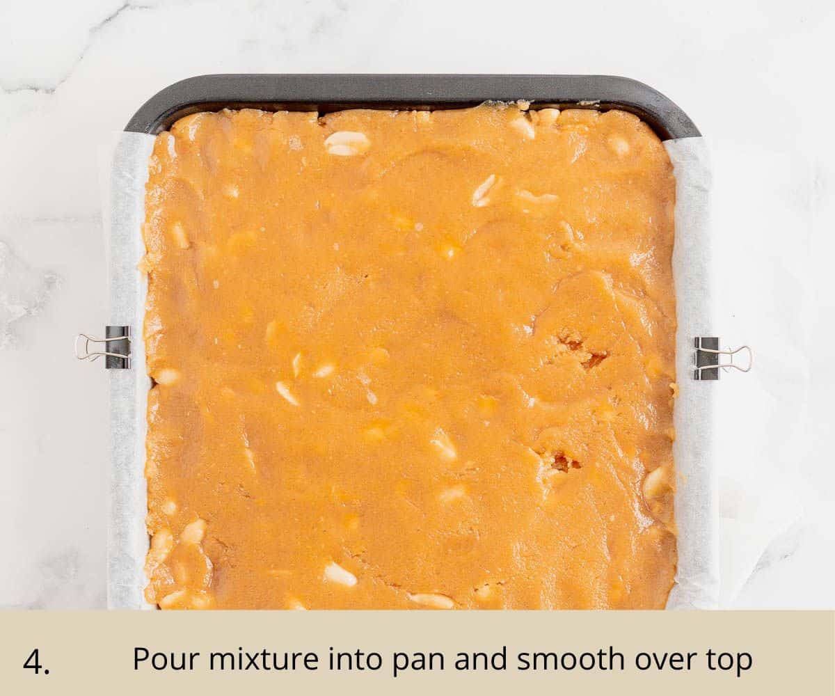 pressing blondie mixture into lined baking tin